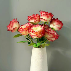 Arrangement of vibrant Apple Jack roses in white vase